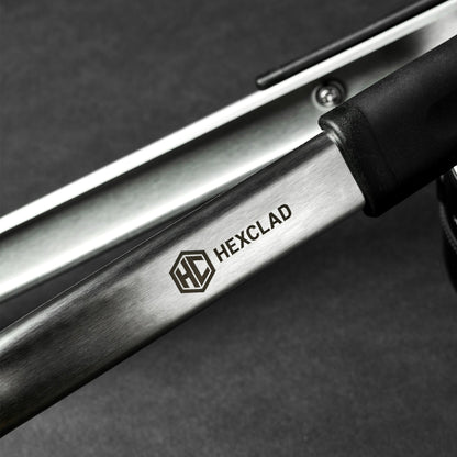 A closeup of the HexClad logo on a pair of tongs.