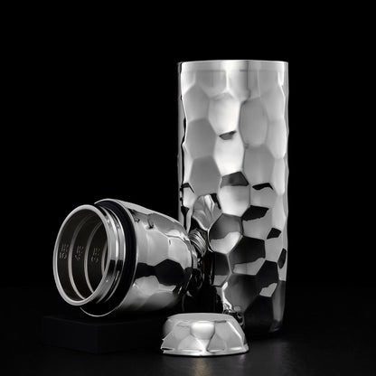 Silver/Chrome hexclad cocktail shaker open displaying the geometric pattern on a black background