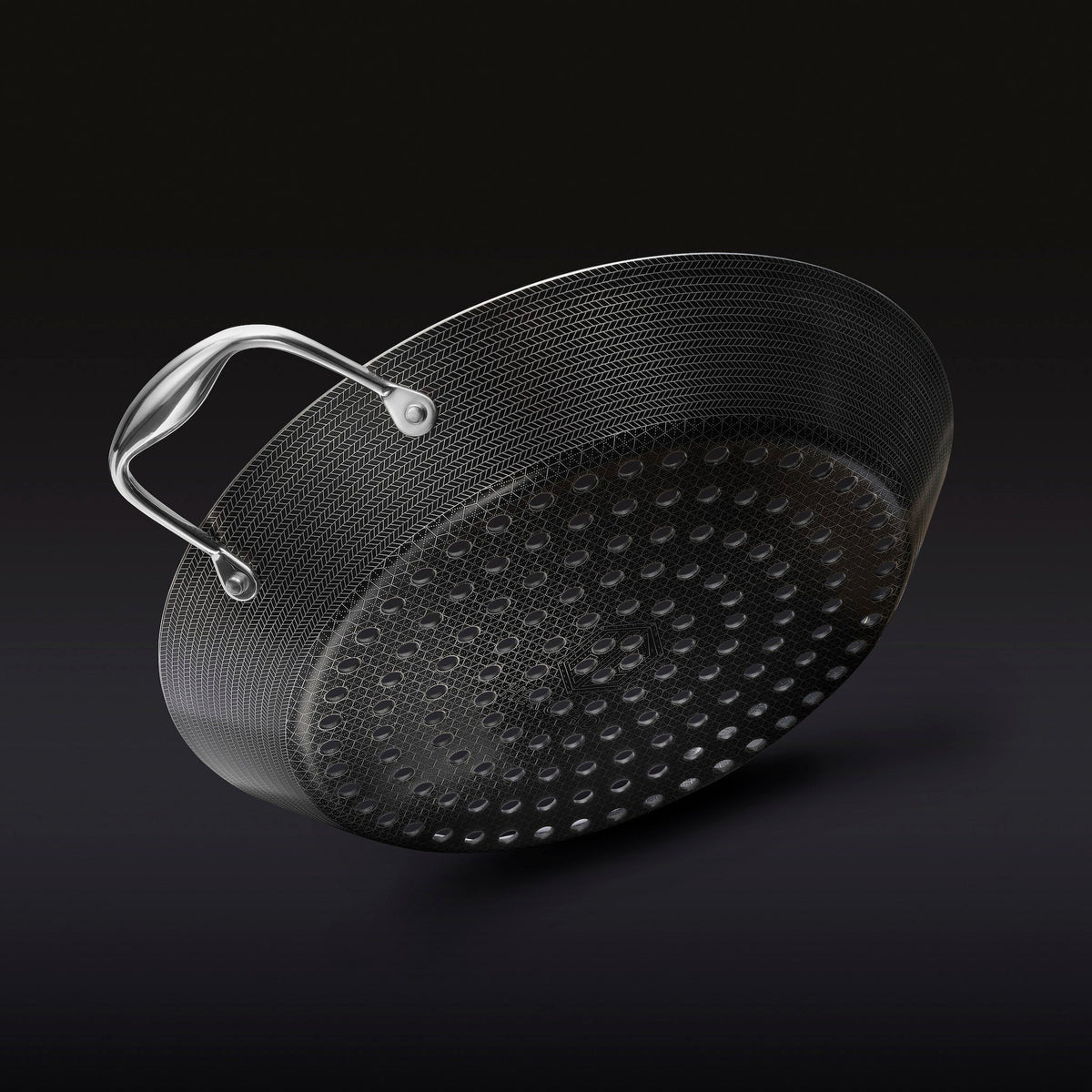 The underside of the HexClad 12&quot Hybrid BBQ Grill Pan on a black background